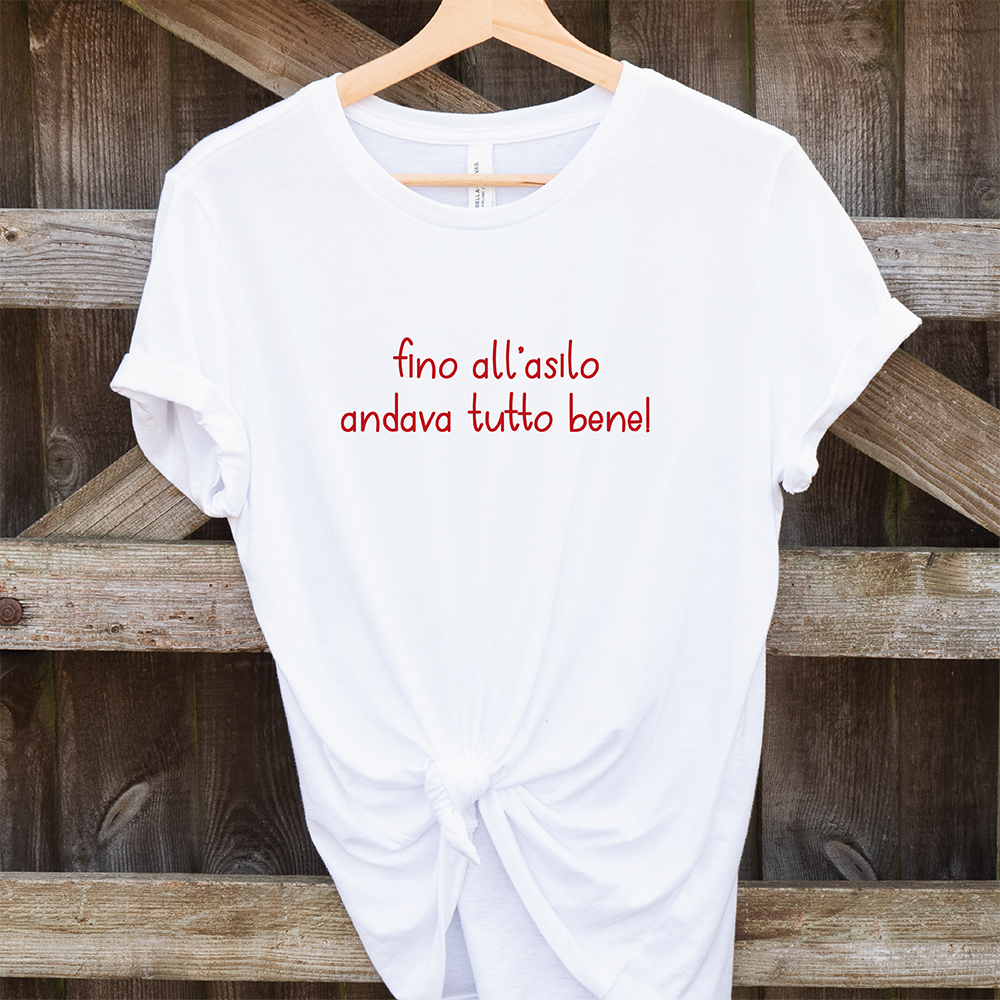 La T-shirt Asilo di Il mio negozio, bianca con scritta rossa "fino all'asilo andava tutto bene!", è perfetta per t-shirt personalizzate o come idea regalo originale.