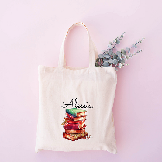 Tote bag personalizzata con nome e grafica con pila di libri rossi, shopper in cotone bianca con nome personalizzabile