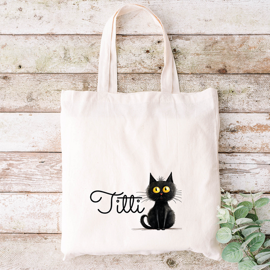 Borsa in tela con un simpatico gatto nero e la stampa "Tilli", accanto a foglie verdi - si abbina perfettamente al nostro Specchietto Tondo di In Casa di Ale per un set coordinato.