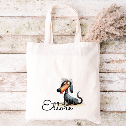 Tote bianca con bassotto cartoon e scritta "Ettore", raffigurata su legno: un divertente abbinamento con lo Specchietto Tondo di In Casa di Ale per uno stile coordinato e personalizzato.