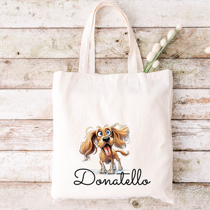 Borsa tote beige con un cane dei cartoni animati, il nome Donatello e fiori secchi all'interno: perfetta da abbinare allo Specchietto Tondo di In Casa di Ale per un tocco affascinante e personalizzato.